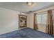 Bedroom with a light fixture, window, and blue carpet at 7131 E Cholla St, Scottsdale, AZ 85254