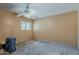 A bedroom with a ceiling fan, window, and peach colored walls at 7131 E Cholla St, Scottsdale, AZ 85254