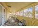 Bright enclosed patio featuring tile flooring, brick accents, and large windows offering abundant natural light at 7131 E Cholla St, Scottsdale, AZ 85254