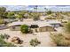 This home features unique landscaping, with a mix of desert plants and an old rusty car placed as art at 7131 E Cholla St, Scottsdale, AZ 85254