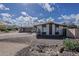 Charming single-story home with a brick facade, low-maintenance desert landscaping, and a covered carport at 7131 E Cholla St, Scottsdale, AZ 85254