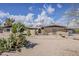 Attractive single-story home with a brick facade, desert landscaping, and a walled courtyard at 7131 E Cholla St, Scottsdale, AZ 85254