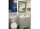 Bathroom with a white vanity, toilet, and dark-stained cabinet above the toilet at 7750 E Broadway Rd # 433, Mesa, AZ 85208