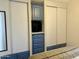 Bedroom features built-in storage around a television, flanked by sliding door closets with ample storage at 7750 E Broadway Rd # 433, Mesa, AZ 85208