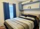 Inviting bedroom features a bed, built-in shelving, and a window for natural light at 7750 E Broadway Rd # 433, Mesa, AZ 85208