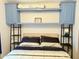 The bedroom features a neatly made bed with overhead storage, complemented by bedside lamps at 7750 E Broadway Rd # 433, Mesa, AZ 85208