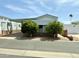 Charming single-story home with carport and mature trees adding curb appeal at 7750 E Broadway Rd # 433, Mesa, AZ 85208