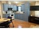 Functional kitchen featuring light blue cabinets, appliances, and an adjoining dining area at 7750 E Broadway Rd # 433, Mesa, AZ 85208
