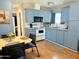 Cozy kitchen features blue cabinets, white appliances, and a view from the window at 7750 E Broadway Rd # 433, Mesa, AZ 85208