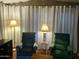 Cozy living room with comfortable armchairs, lamps, and curtains, providing a relaxing and inviting space at 7750 E Broadway Rd # 433, Mesa, AZ 85208