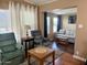 Inviting living room with comfortable seating, wooden tables, and natural light filtering through the curtains at 7750 E Broadway Rd # 433, Mesa, AZ 85208