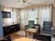 Comfortable living room with plush armchairs, natural light and modern entertainment center at 7750 E Broadway Rd # 433, Mesa, AZ 85208