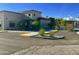 Parking lot outside of a building at Carriage Manor Resort with sidewalks and desert landscaping at 7750 E Broadway Rd # 433, Mesa, AZ 85208