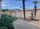 Swimming pool, water fountain, and palm trees at Carriage Manor Resort under a sunny sky at 7750 E Broadway Rd # 433, Mesa, AZ 85208