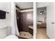 Elegant bathroom showcases a tiled shower with a built-in seat and a glimpse into the Primary bedroom at 7811 N 32Nd Ave, Phoenix, AZ 85051