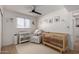 Bright Bedroom featuring a crib, changing station, cozy armchair, and a calming, -friendly design at 7811 N 32Nd Ave, Phoenix, AZ 85051