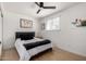 Cozy bedroom featuring a full-sized bed with modern decor, a ceiling fan, and ample natural light at 7811 N 32Nd Ave, Phoenix, AZ 85051