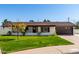 Charming single-story home showcasing a well-manicured lawn, covered porch, and a two-car garage at 7811 N 32Nd Ave, Phoenix, AZ 85051