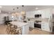 Modern kitchen featuring white cabinetry, stainless steel appliances, and a spacious island with bar seating at 7811 N 32Nd Ave, Phoenix, AZ 85051