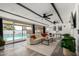Open living room with large windows, pool view, and comfortable seating arrangement at 7811 N 32Nd Ave, Phoenix, AZ 85051