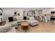 Bright and airy living room featuring a large sectional sofa and seamless flow to the kitchen at 7811 N 32Nd Ave, Phoenix, AZ 85051