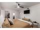 Spacious main bedroom with a TV, dresser, and a peek into the luxurious walk-in closet and en suite bathroom at 7811 N 32Nd Ave, Phoenix, AZ 85051