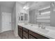 Bathroom featuring a double vanity with modern fixtures and a well-lit mirror at 797 W Danish Red Trl, San Tan Valley, AZ 85143