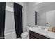 Bathroom featuring a white vanity, toilet, and shower/tub combo with a dark curtain at 797 W Danish Red Trl, San Tan Valley, AZ 85143