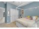 A blue bedroom features a canopy bed with storage drawers and colorful decor at 797 W Danish Red Trl, San Tan Valley, AZ 85143