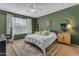 Cozy bedroom with dark green walls, and neutral accents, creating a peaceful retreat at 797 W Danish Red Trl, San Tan Valley, AZ 85143