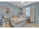 A blue bedroom features a canopy bed with storage drawers, colorful decor, and neutral carpet at 797 W Danish Red Trl, San Tan Valley, AZ 85143