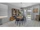 Bright dining area with backyard views, featuring a bookshelf and stylish decor at 797 W Danish Red Trl, San Tan Valley, AZ 85143