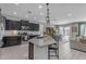 Modern kitchen with dark cabinets, granite countertops, and a center island at 797 W Danish Red Trl, San Tan Valley, AZ 85143