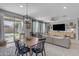 Open concept living space features a dining area and comfortable seating arrangement with a TV at 797 W Danish Red Trl, San Tan Valley, AZ 85143
