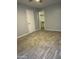Bedroom featuring neutral walls, wood-look tile flooring, and a walk-in closet at 8101 N 107Th Ave # 26, Peoria, AZ 85345
