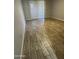 Bedroom with wood-look tile flooring and a sliding glass door with vertical blinds at 8101 N 107Th Ave # 26, Peoria, AZ 85345