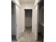 Hallway with tile floor, linen closet, and view into the bathroom at 8101 N 107Th Ave # 26, Peoria, AZ 85345