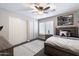 Well-lit bedroom with neutral walls, ceiling fan, and plush carpeting at 8260 W Cielo Grande Ave, Peoria, AZ 85383