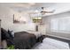Cozy bedroom with a ceiling fan, white dresser, and decorative rug at 8260 W Cielo Grande Ave, Peoria, AZ 85383