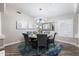 Dining room offering a round table with seating, complemented by stylish decor and ample natural light from the window at 8260 W Cielo Grande Ave, Peoria, AZ 85383