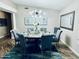 Stylish dining room featuring a modern chandelier, a round table with seating for six, and a decorative rug at 8260 W Cielo Grande Ave, Peoria, AZ 85383