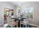 Cozy dining area with a stylish table set, chandelier lighting, and natural light from the sliding glass door at 8260 W Cielo Grande Ave, Peoria, AZ 85383