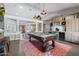 Bright game room boasting a pool table, wooden flooring, and a stylish wet bar for entertaining guests at 8260 W Cielo Grande Ave, Peoria, AZ 85383