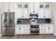 Gourmet kitchen featuring stainless steel appliances, custom cabinets, granite countertops and wood floors at 8260 W Cielo Grande Ave, Peoria, AZ 85383