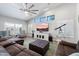 Spacious living room features high ceilings, large windows, stylish furniture, and modern ceiling fan at 8260 W Cielo Grande Ave, Peoria, AZ 85383
