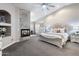 Spacious main bedroom with a stone fireplace, plush carpeting, and elegant decor for relaxation at 8260 W Cielo Grande Ave, Peoria, AZ 85383