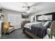 Comfortable main bedroom featuring a ceiling fan, plantation shutters, and a cozy sitting area at 8260 W Cielo Grande Ave, Peoria, AZ 85383
