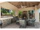 Elegant outdoor kitchen with a grill, seating, and fireplace, perfect for entertaining in a luxurious outdoor space at 8260 W Cielo Grande Ave, Peoria, AZ 85383