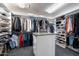Organized walk-in closet with ample shelving, hanging space, and a center island for convenient storage at 8260 W Cielo Grande Ave, Peoria, AZ 85383