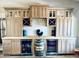 Custom wet bar featuring wooden cabinetry, wine storage, and built-in beverage coolers for ultimate convenience at 8260 W Cielo Grande Ave, Peoria, AZ 85383